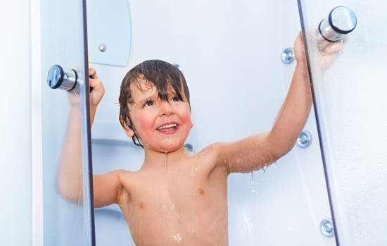 Boy taking shower in the hotel cabin with smile