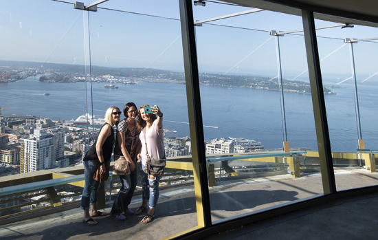 Guests take a selfie on the Space Needle’s open-air observation deck, located 520-feet in the air
