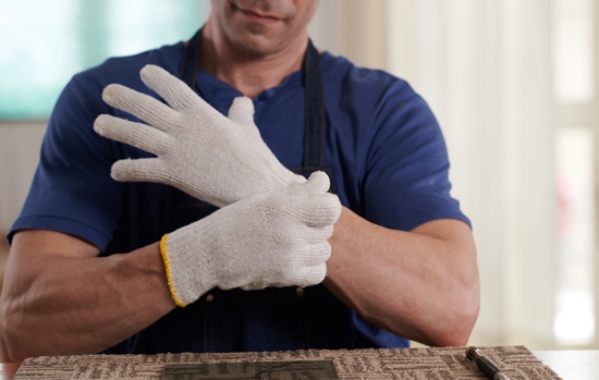 Worker wearing gloves before work